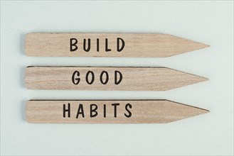 The words build good habits are standing on arrows, change lifestyle, healthy and positive