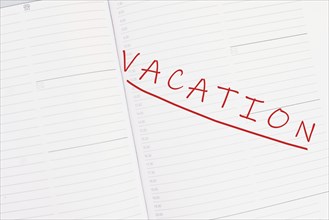 The word vacation is standing in the calendar, planning for the holiday, summer break