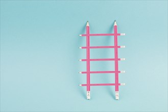 Ladder of success build with pencils, opportunity strategy, blue background, copy space for text,