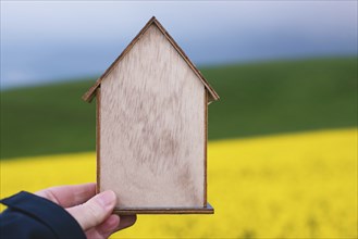 Wooden house in a meadow, buying or renting a house in nature, real estate concept, booking home