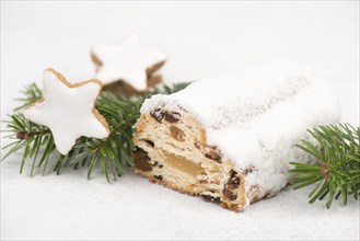 Christstollen, traditonal christmas cake with nuts, raisons, marzipan on a blue background, empty