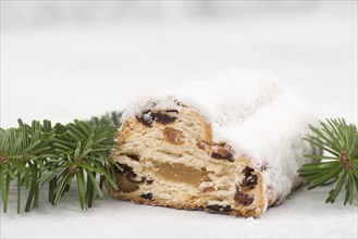 Christstollen, traditonal christmas cake with nuts, raisons, marzipan on a blue background, empty