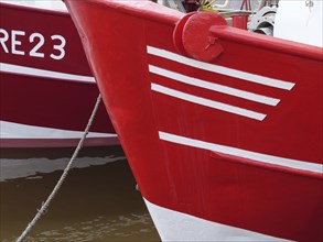 Close-up of two red fishing boats in the harbour, ready for action, greetsiel, east frisia, germany