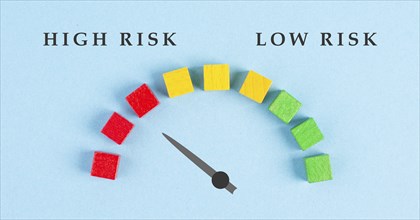 Tachometer high and low risk, pointer is showing to the red risky scale, financial credit and