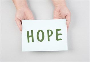 The word hope is standing on a paper, positive mindset, optimism for the future