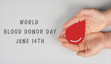 Holding a red drop in the hands, donate blood, world blood donor day, health care, transfusion