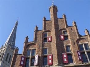 Gothic architecture with red bricks and shutters against a blue sky, Doesburg, Gelderland,