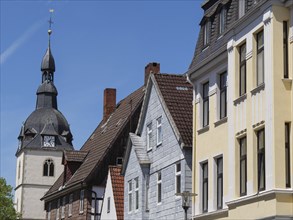 Historic church behind a row of half-timbered houses, taken under a blue sky, Detmold, North