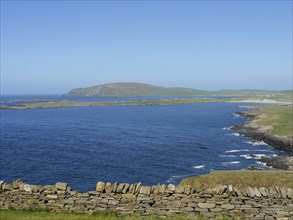 Wide view over the blue sea to hilly islands and a clear sky, lerwick, shetlands, scotland, great