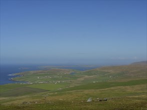 Extensive hilly landscape with a view of the sea in the background, lerwick, shetlands, scotland,