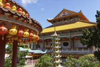 View of a magnificent temple with numerous lanterns and golden roofs on a sunny day, Pattaya,