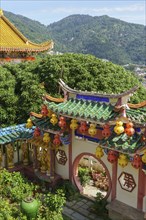 Traditional Chinese architecture surrounded by green mountains and colourful lanterns, Pattaya,