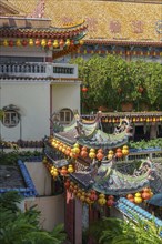 Detail of traditional Chinese architecture with lanterns and green vegetation, Pattaya, Thailand,