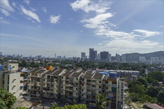 View of a city with modern skyscrapers and residential buildings under a cloudy sky, Pattaya,