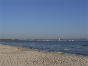 Wide sandy beach with small waves and a view of the distant shore, Binz, Rügen, Germany, Europe