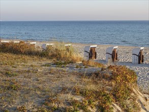 Sunset over a dune landscape with beach chairs by the sea, Binz, Rügen, Germany, Europe