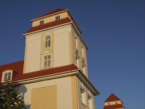 Close-up of an impressive historic building with white facades and red roofs in the sunlight, Binz,