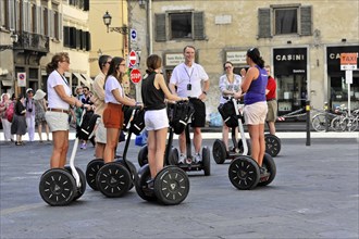 Florence, Tuscany, Italy, Europe, A group of people on Segways on a city tour on a sunny day,