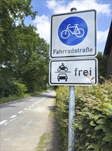 Traffic sign Bicycle road underneath sign with pictogram for cars motorbikes free, left at the edge