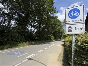 Traffic sign Bicycle road underneath sign with pictogram for cars motorbikes free, left at the edge