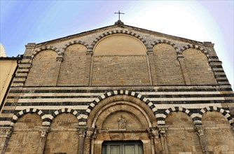 Volterra, Tuscany, Italy, Europe, Exterior view of a church with a stone faÃ§ade and a cross on