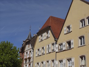 Traditional houses in an old town centre with steep roofs and many windows, Wissembourg, Alsace,