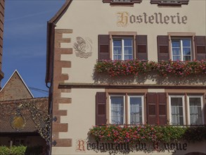 A traditional restaurant in a historic half-timbered house, decorated with flowers and a coat of