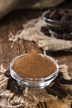 Milled Cola Nut (close-up shot) on rustic wooden background