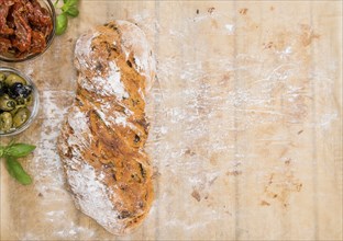 Ciabatta bread with sundried Tomatoes, Basil and Olives (close-up shot)