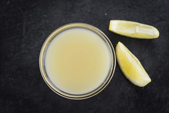 Fresh made Juice (lemon) on a vintage background (close-up shot)