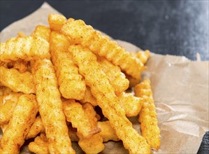 Portion of Chips on dark background (detailed close-up shot)