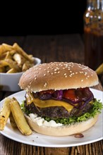 Homemade Burger with French Fries on an old wooden table