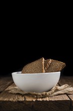 Slices of Brown Bread (selective focus) on an old wooden table