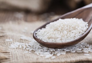 Portion of uncooked Rice on rustic wooden background