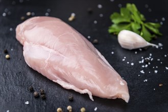 Slate slab with fresh Chicken Meat (close-up shot) on a slate slab