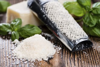 Grated Parmesan with Basil on dark vintage background