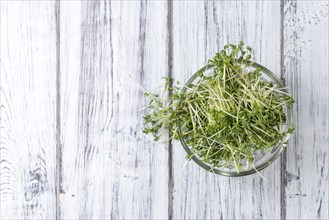 Portion of Cress (close-up shot) on rustic wooden background