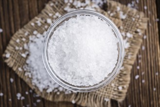 Coarse Salt (selective focus, close-up shot) on a dark vintage background