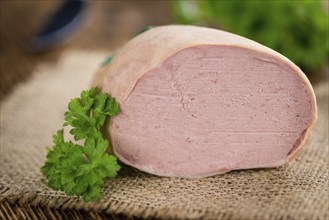 Liverwurst on a vintage background as detailed close-up shot (selective focus)