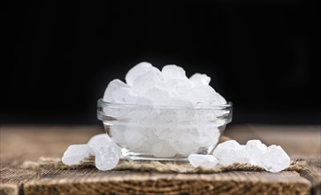 White Rock Candy on wooden background (detailed close-up shot, selective focus)