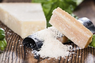 Heap of grated Parmesan (close-up shot) on wooden background