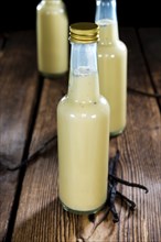 Vanilla Milkshake on an old wooden background (close-up shot)