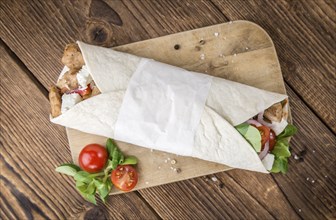 Homemade Chicken Wrap (close-up shot) on vintage background (selective focus)