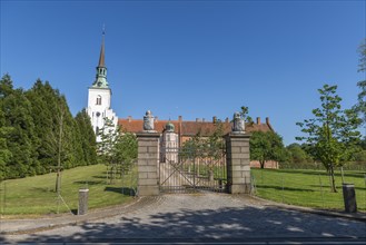 Brahetrolleborg church and castle, castle entrance, lions with coat of arms, trees, lawn, Faborg,