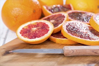 Portion of fresh and juicy Blood Orange on wooden background