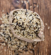 Portion of Mixed Rice (close-up shot) on wooden background