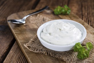 Fresh made Sour Cream (selective focus) on vintage wooden background