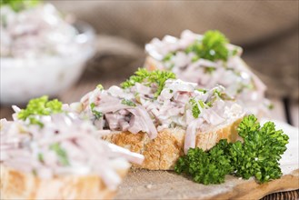 Bread and Meat Salad (made with Mayonnaise and fresh parsley) on wood