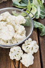 Portion of fresh Cauliflower on wooden background