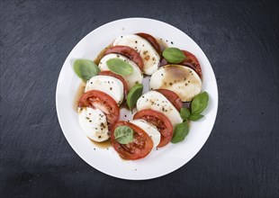 Tomatoes with Mozzarella and Balasimco dressing (selective focus)